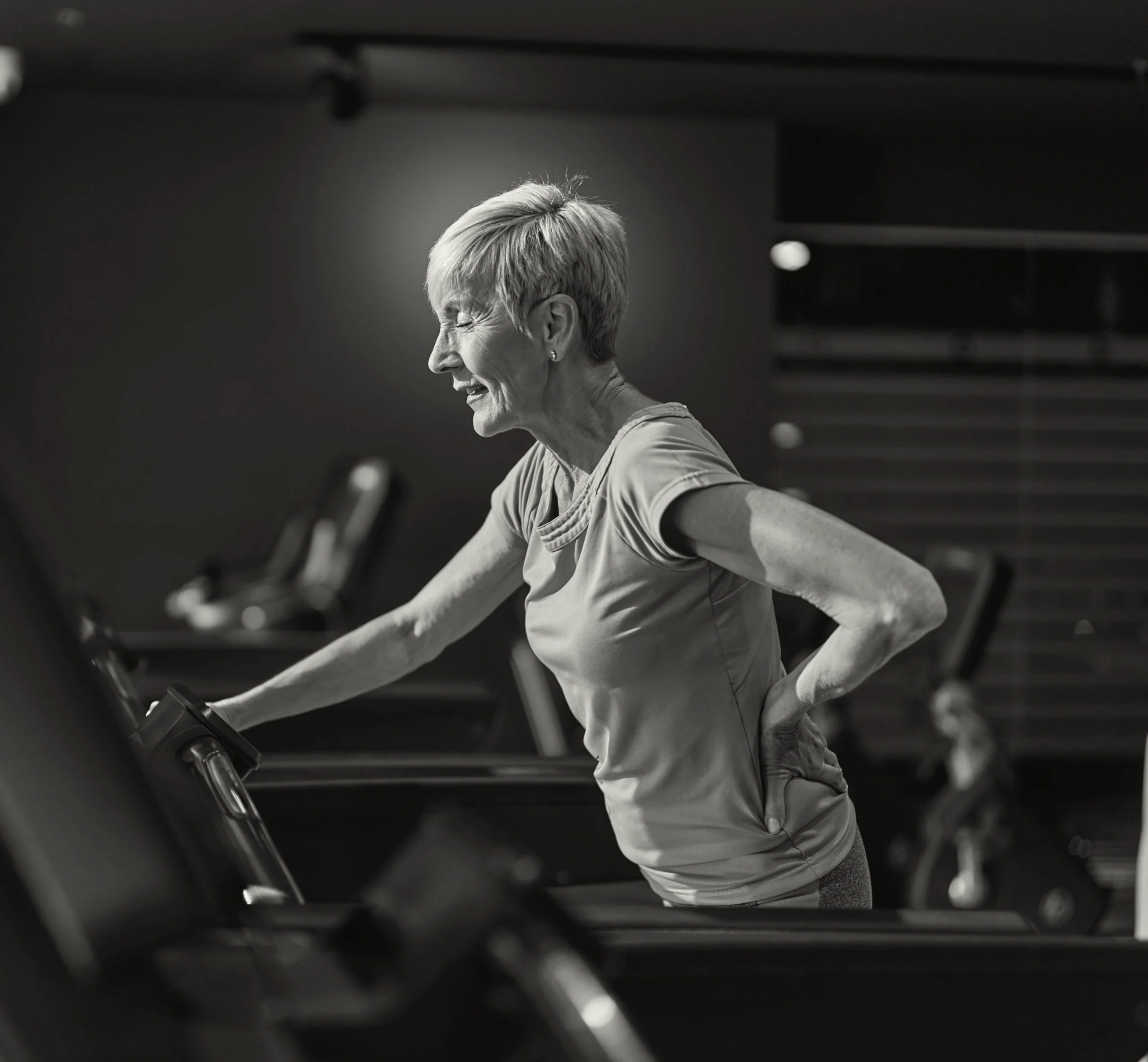 Woman running on a treadmill during a gym workout.